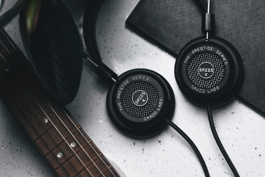 The Grado SR225x headphones alongside a guitar