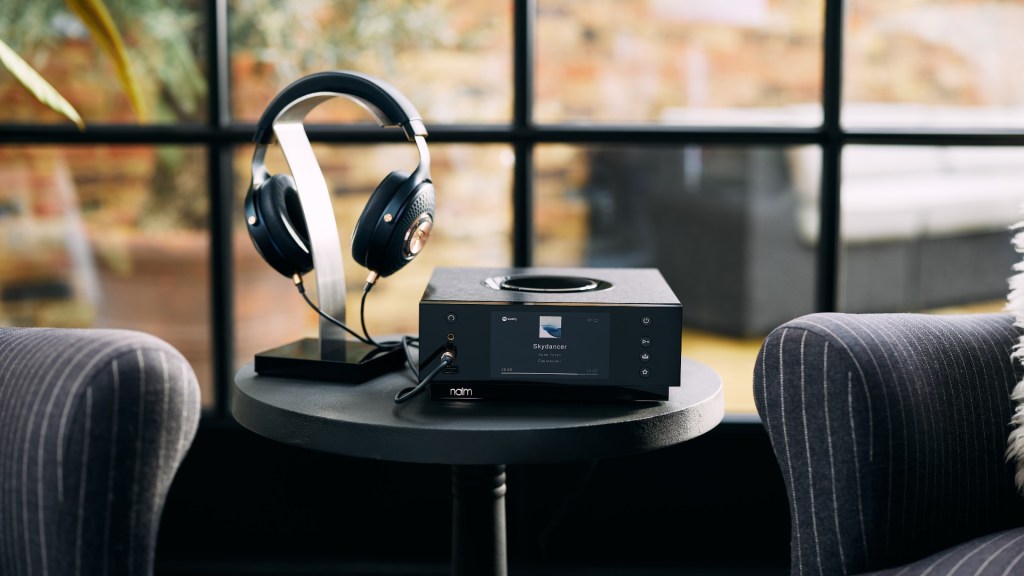 Uniti Atom Headphone Edition Hi-Fi with headphones in a living room setting