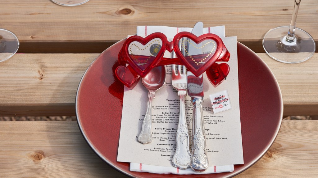 The menu with Elton Johhn style glasses at Dine and Disco event 2021