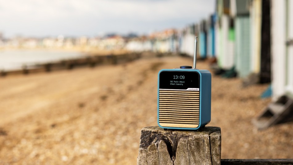 Ruark Audio R1 Mk4 digital radio on the beach in front of beach huts