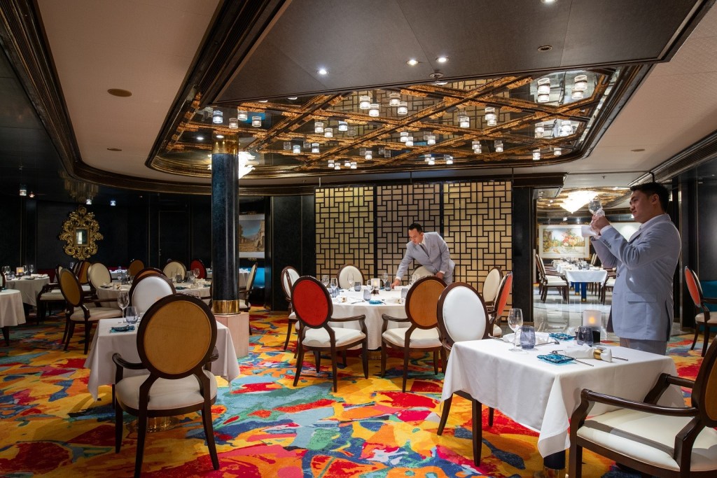 Waiters prepare glasses in Fred Olsen Borealis Colours & Tastes restaurant