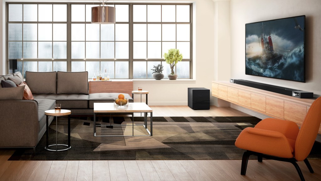 A Klipsch Cinema 1200 soundbar under a TV in a minimalistic living room