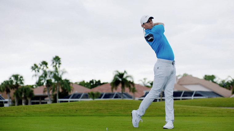 Golf superstar Rory McIlroy takes a swing on the green