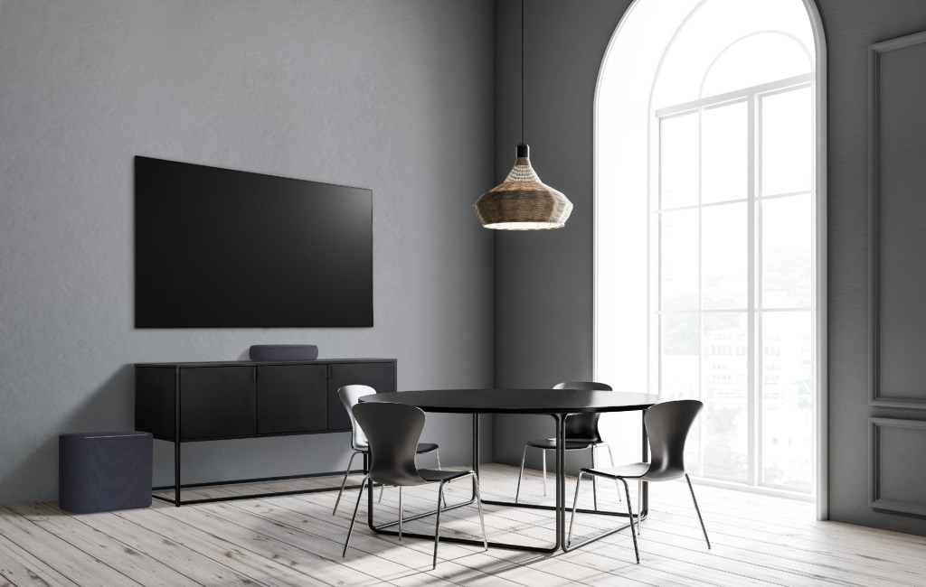 The black version of the LG Éclair soundbar in a black-clad living room