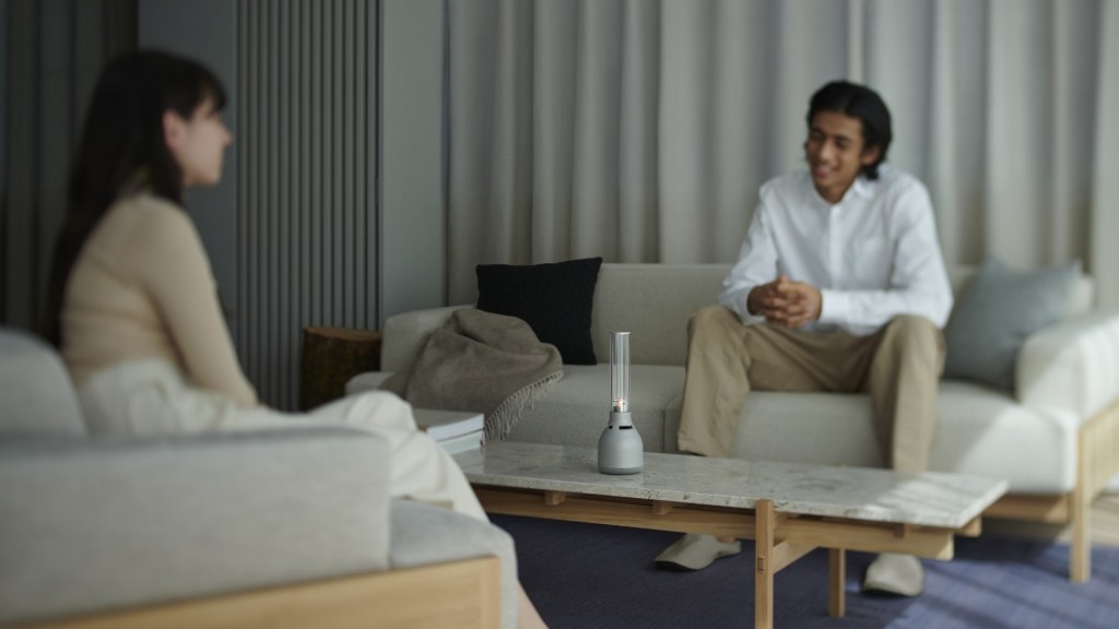 A young couple chat around the LSPX-S3 Sony light speaker