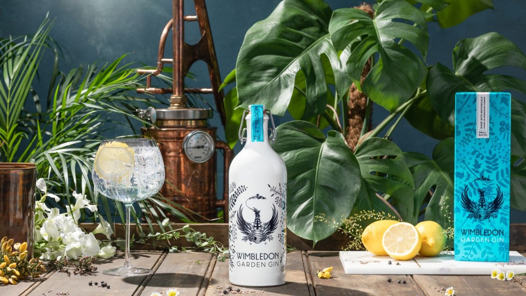 A Wimbledon Garden gin bottle surrounded by lemons and a G&T serve
