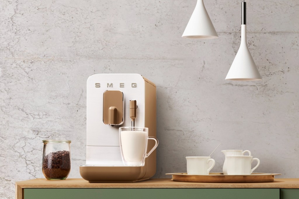 The Smeg BCC02 coffee machine making frothy milk