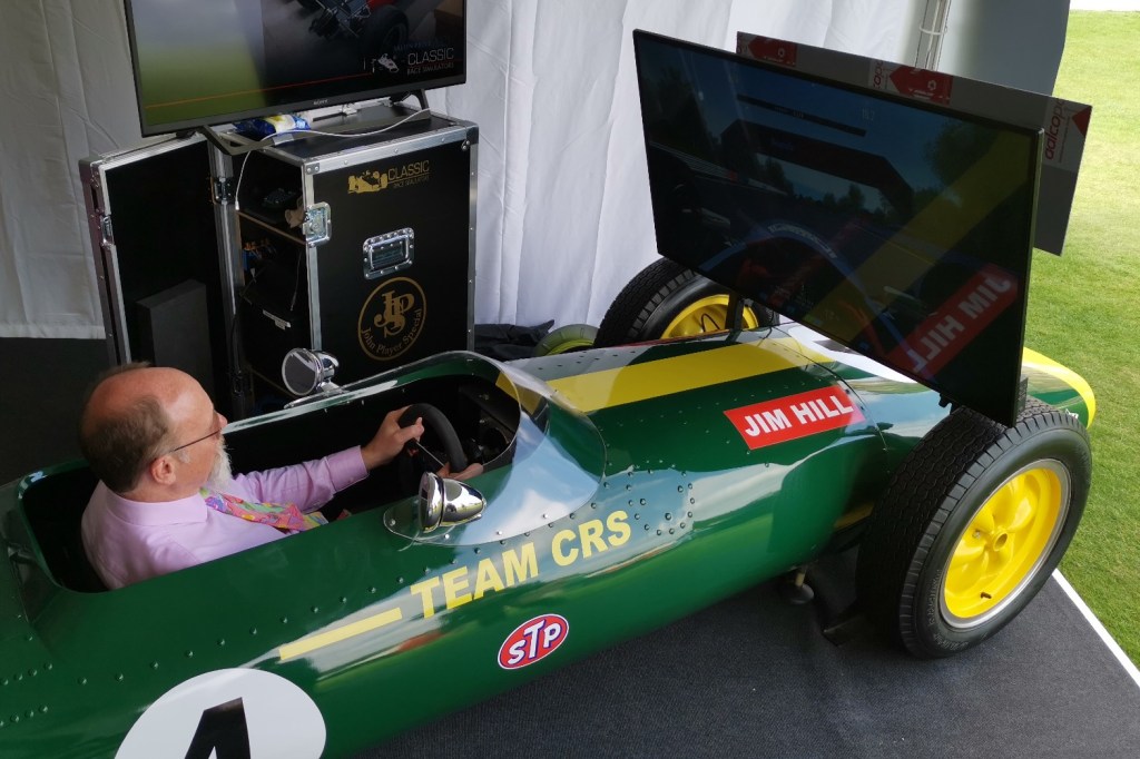 Driver in a race car cockpit racing simulator