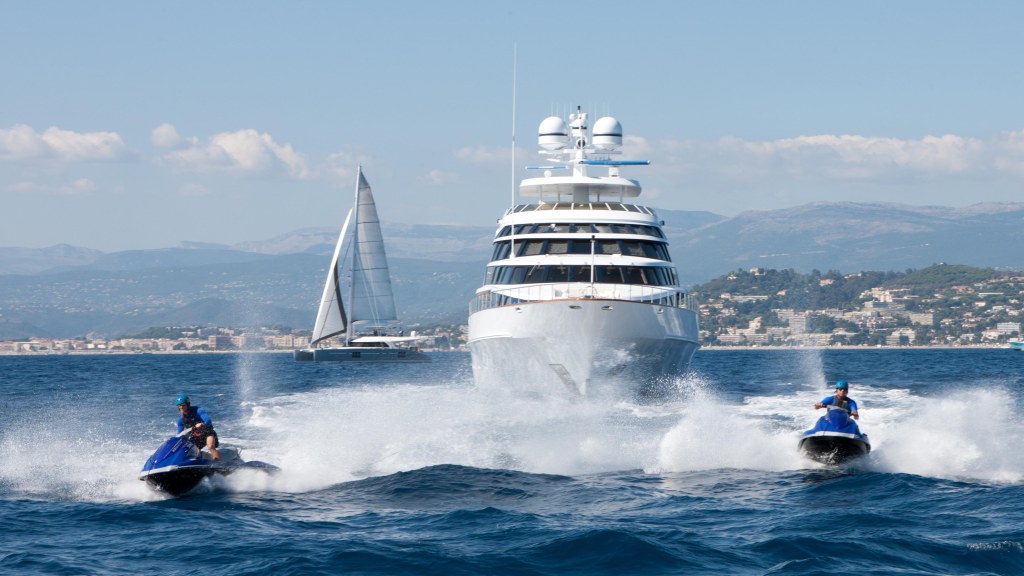 Superyacht Azzurra II flanked by jetskies