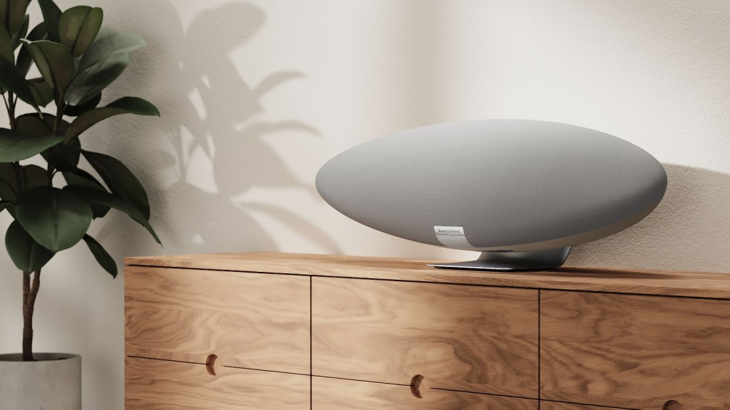 The Pearl Grey Bowers & Wilkins Zeppelin wireless speaker on a wooden sideboard