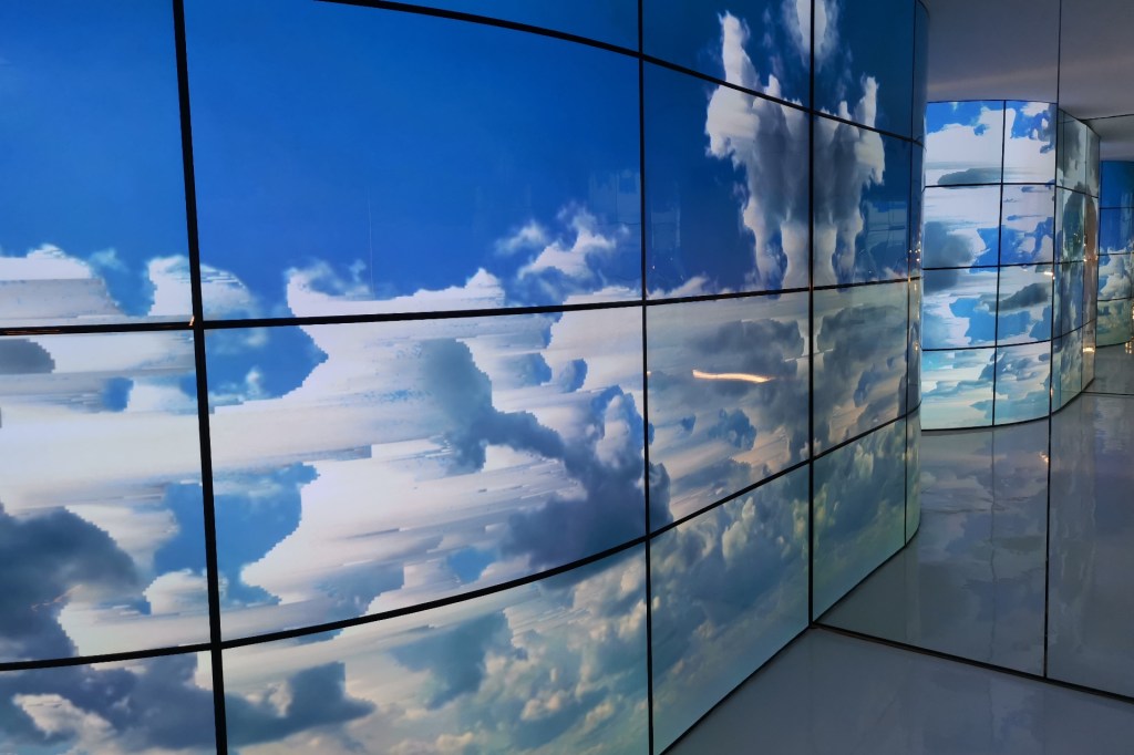 A wall of curved OLED screens at LUX New Wave of Contemporary Art