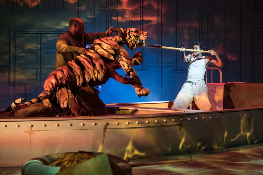 Owain Gwynn is threatened by Richard Parker the Tiger and Hiran Abeysekera (Pi) in Life of Pi. Photo by Johan Persson.