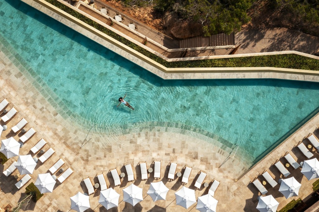 Overhead view of a woman in the poolat Sixth Sense Ibiza