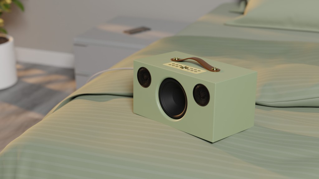 Audio Pro C10 MkII Sage green speaker on a bed