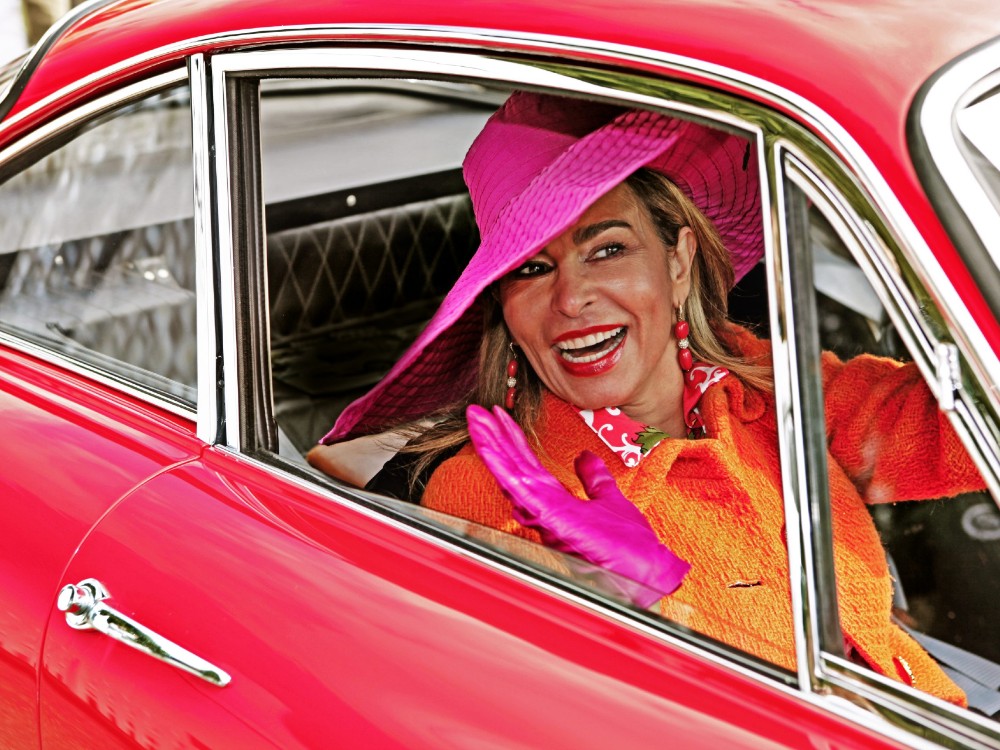 A guest enjoys the classic cars at Salon Privé at Blenheim Palace