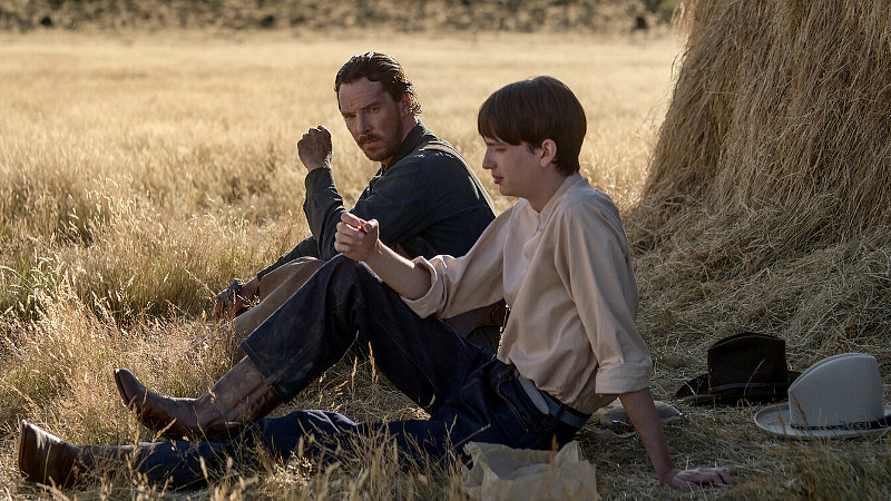 Benedict Cumberbatch sits under a tree in Power of the Dog
