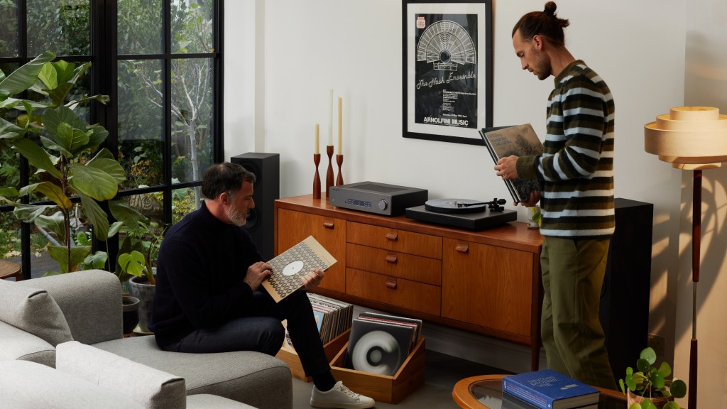 Two music fans sort through records to play on their Cambridge Audio Alva TT V2 record deck