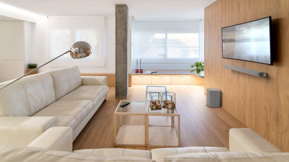 The Harman Kardon Citation MB11000 soundbar is partnered with a subwoofer in this minimalistic apartment