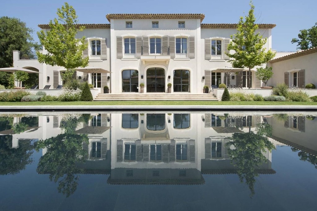 The grand looking Villa La Bergerie reflected in the villa's pool