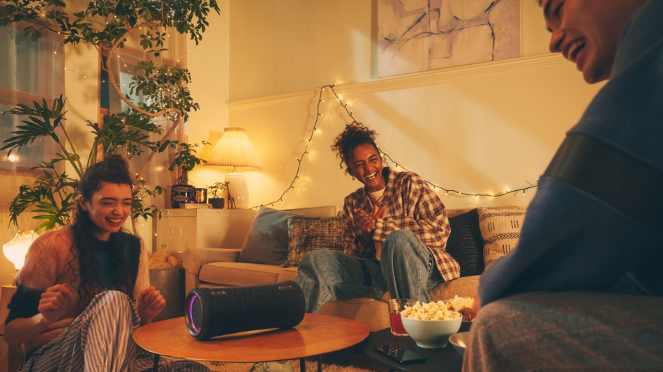 Sony SRS-XG300 portable speaker entertains a group of young people having a party night