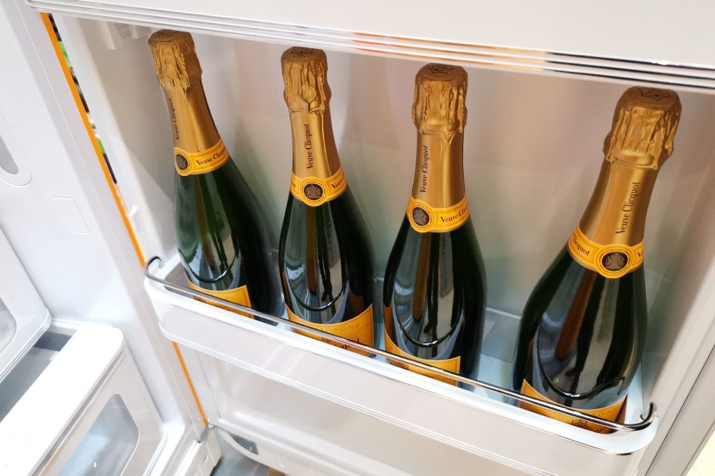 Bottles of Veuve Clicquot chilling in the door of a Smeg FAB28 fridge