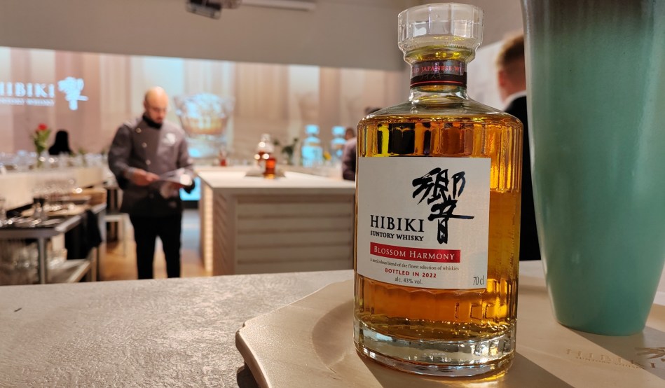 A bottle of Hibiki Blossom Harmony with a chef in the background of its London launch
