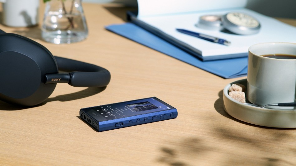 Sony NW-A300 Walkman alongside a pair of headphones and cup of coffee