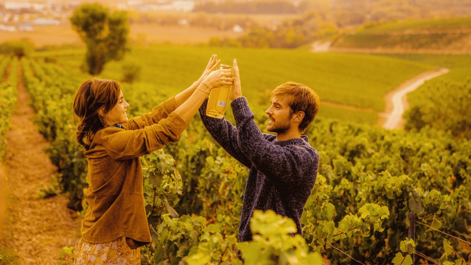 Emma Watson and her brother in the family vineyard with a bottle of gin