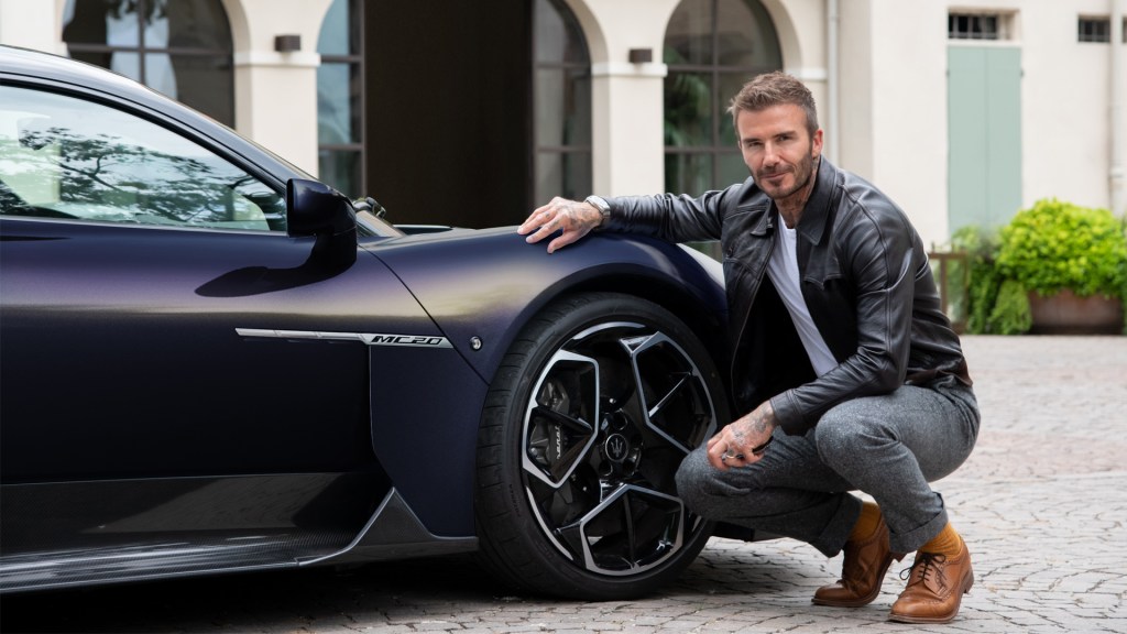 David Beckham kneels before a self styled Maserati MC20