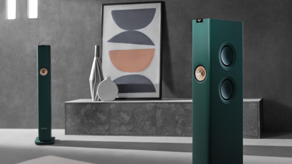 A pair of KEF LS60 Lotus edition speakers in a lifestyle setting with abstract art