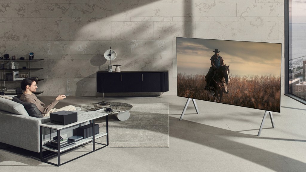 An LG 97inch Signature M3 wireless OLED TV in a fancy modern apartment. The viewer is watching a western.