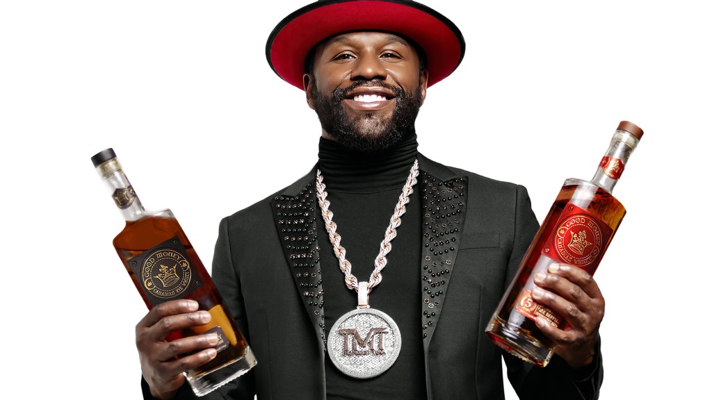 Floyd Mayweather looking dapper as he holds his Good Money whiskies