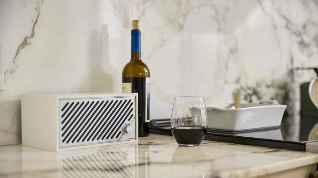 The Tivoli Audio Model 2 Digital wireless speaker alongside a glass or wine