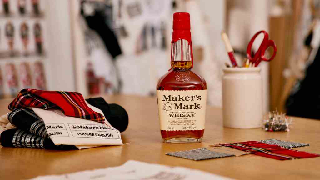 Phoebe English fabrics alongside a bottle of Maker's Mark bourbon