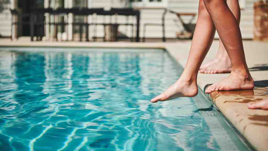 swimmer dips toe in pool