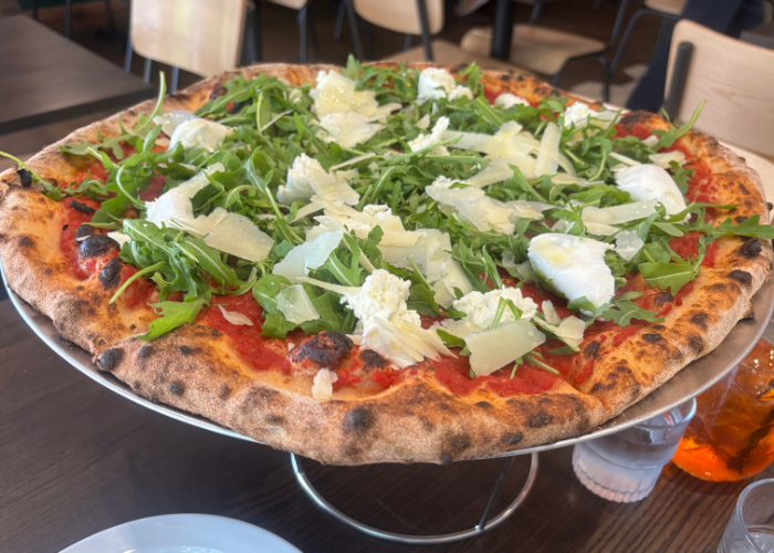The signature Base Face pizza, topped with buffalo mozzarella, rocket, parmesan, basil and garlic oil 