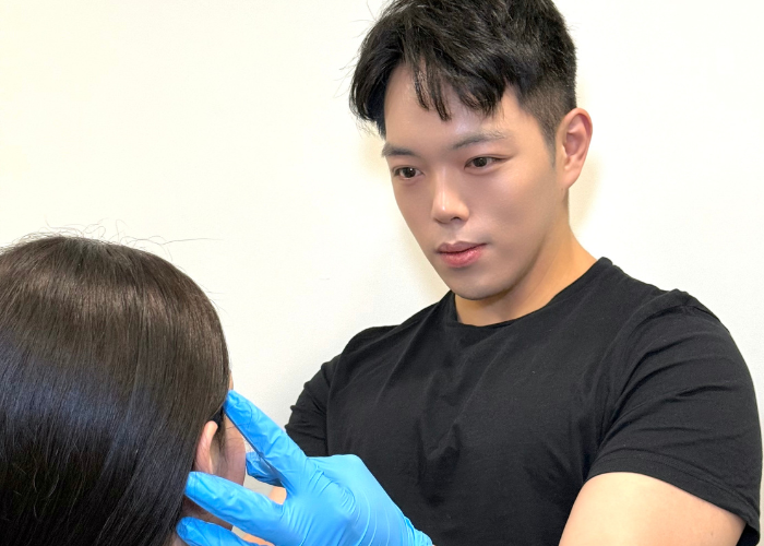 Dr Brendan Khong giving a consultation