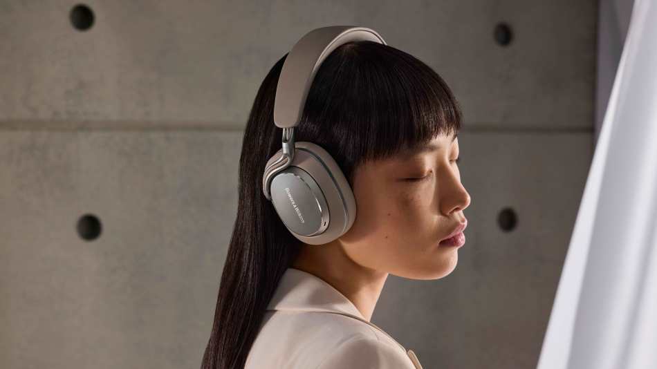 A model wears Bowers Wilkins Px8 S2 Warm Stone headphones