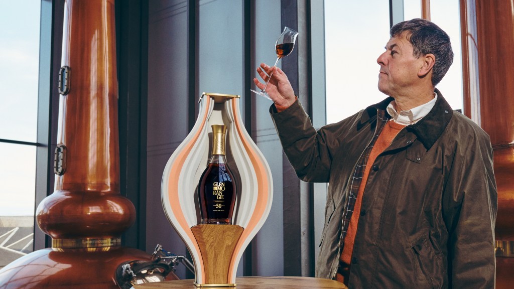 Dr Bill Lumsden holds Glenmorangie 50yo aloft