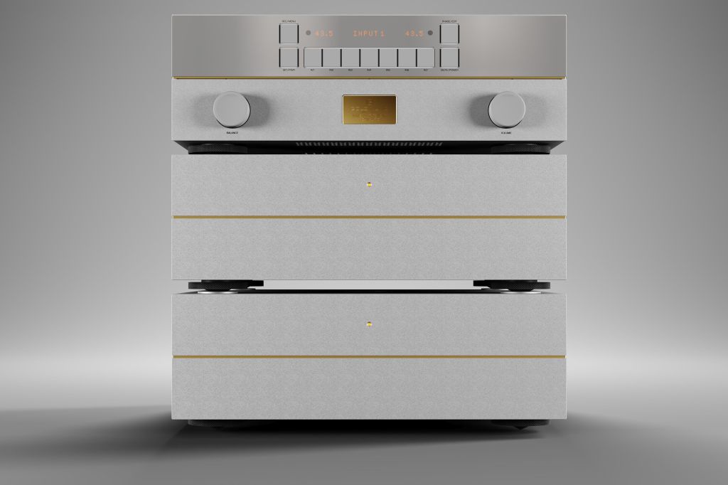 A high-end audio amplifier stack featuring a sleek silver design with gold accents, including two large bottom units and a control panel on top with various buttons and knobs.