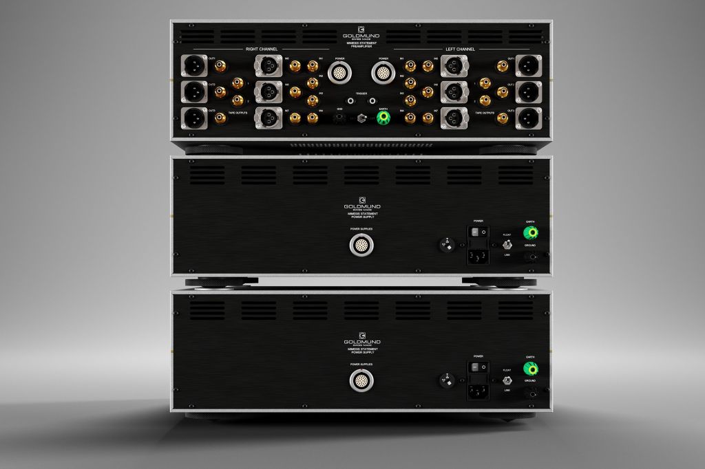 A stacked audio equipment unit featuring multiple input and output connections, including XLR and RCA connectors, with a sleek black and silver design.