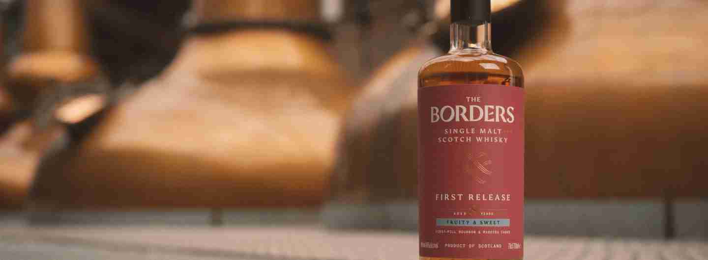 The Borders Distillery - Lifestyle Bottle in front of stills